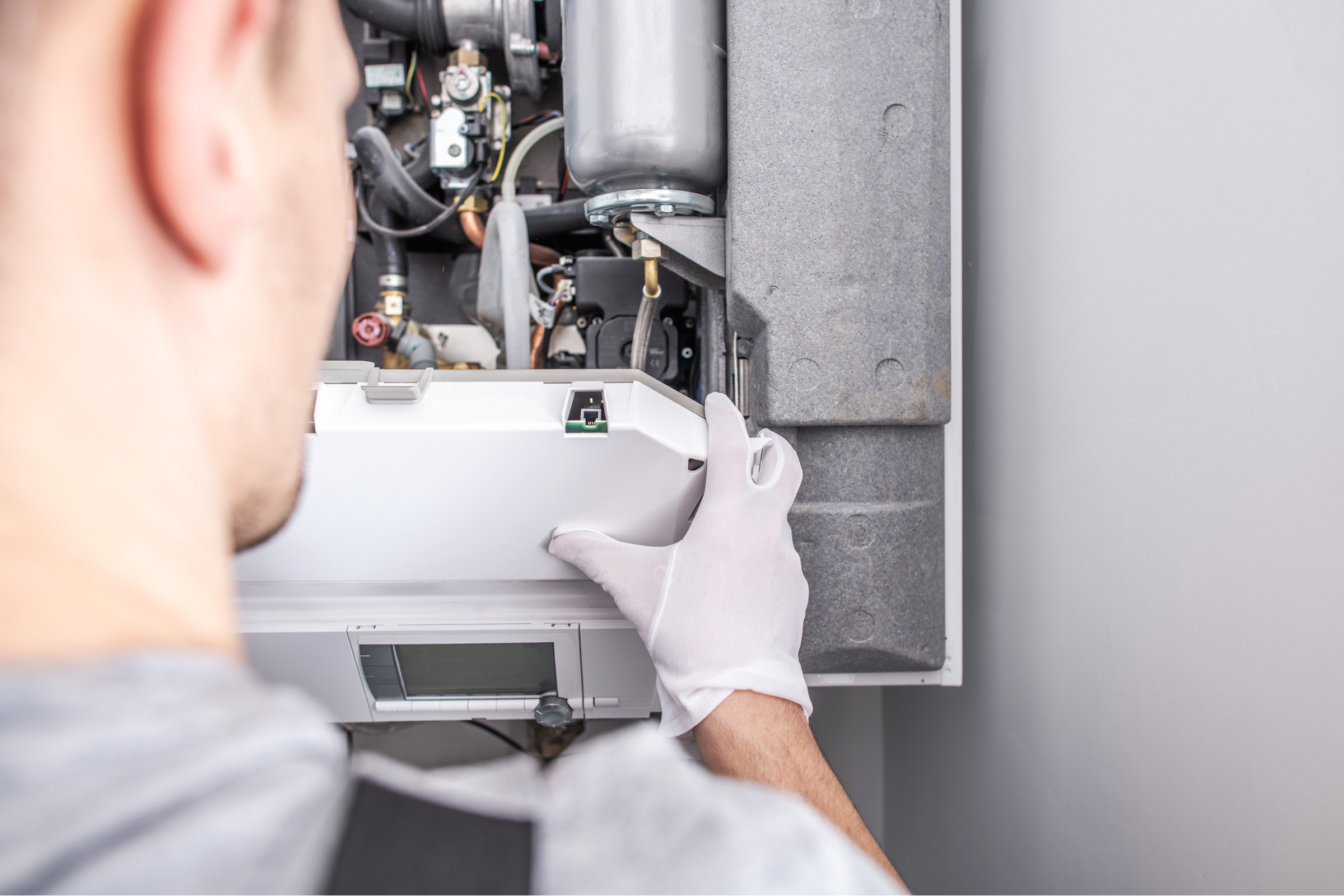 Professional Heating Repair for Reliable Comfort Technician performing professional heating repair on HVAC system, ensuring reliable comfort and efficient operation.